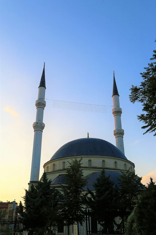 a large mosque is shown with two minalis in the foreground