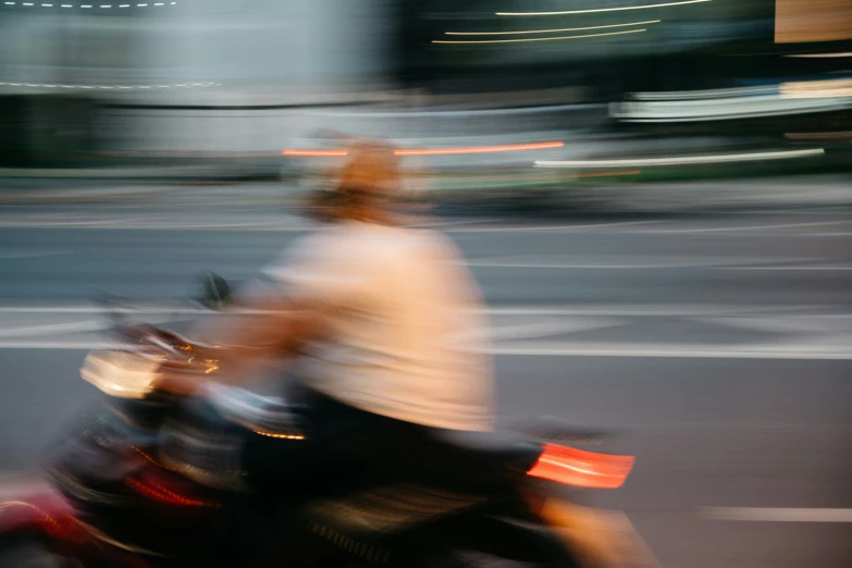 a blurry image of two people riding a motorcycle