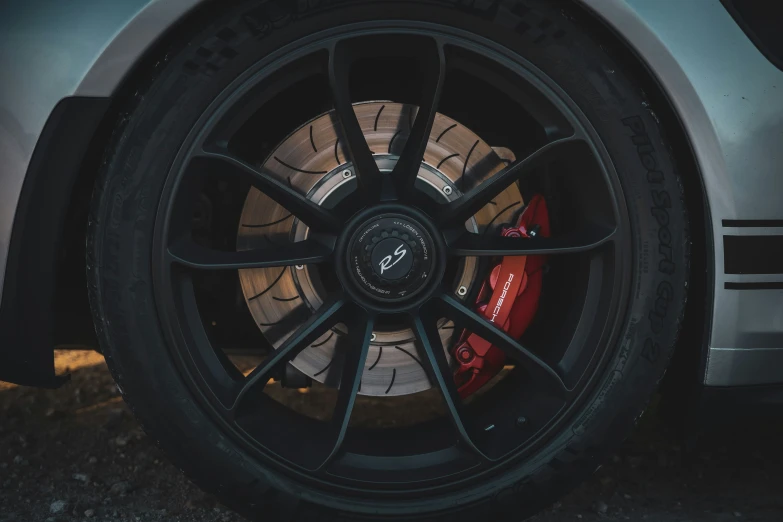 the red ke pads and tire rims of a sports car