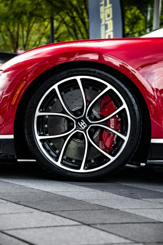 a car wheel on the ground with trees in the background