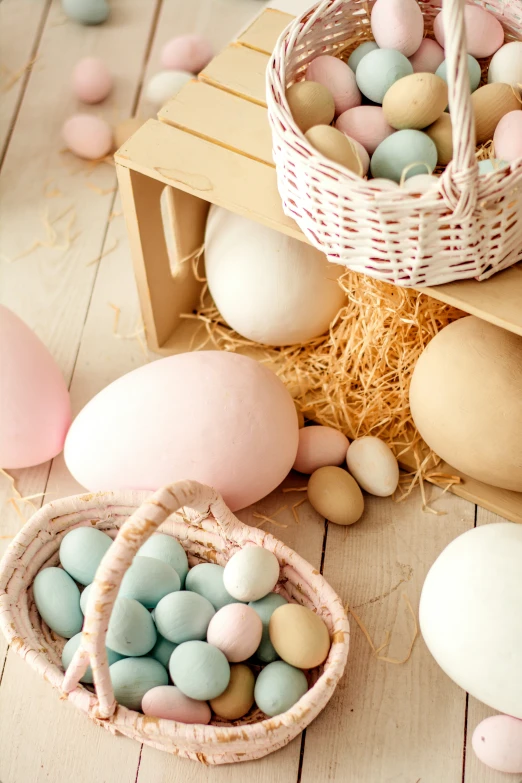 a basket with painted eggs sitting next to other types of decorated eggs