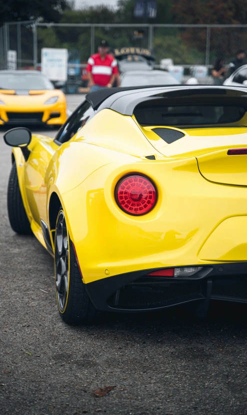 yellow sports cars parked on the street in a parking lot