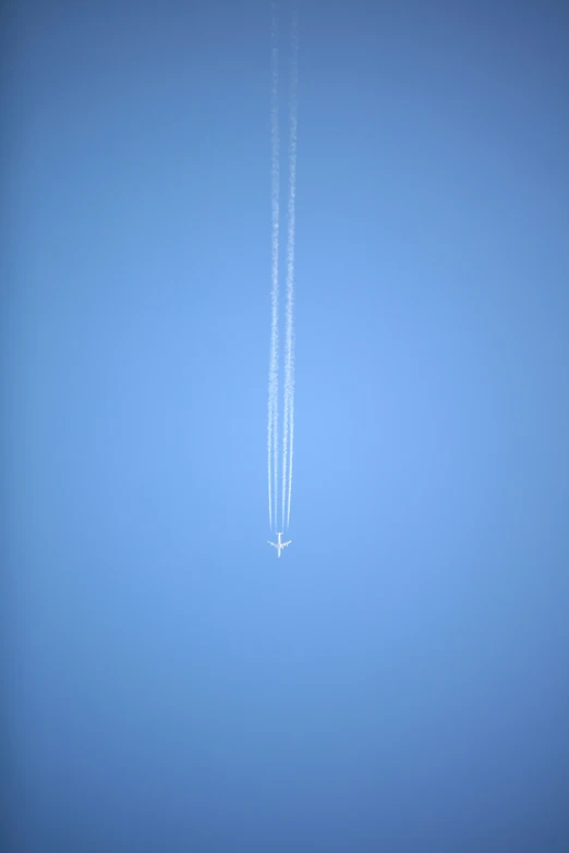 two jets in the sky with contrails behind them