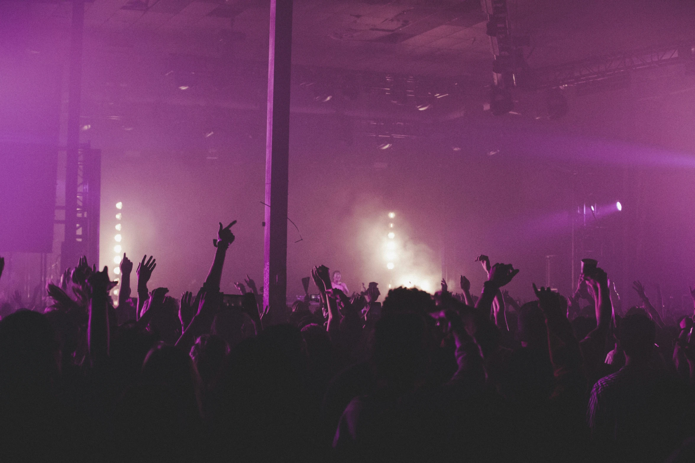 a crowd of people in a room with some lights