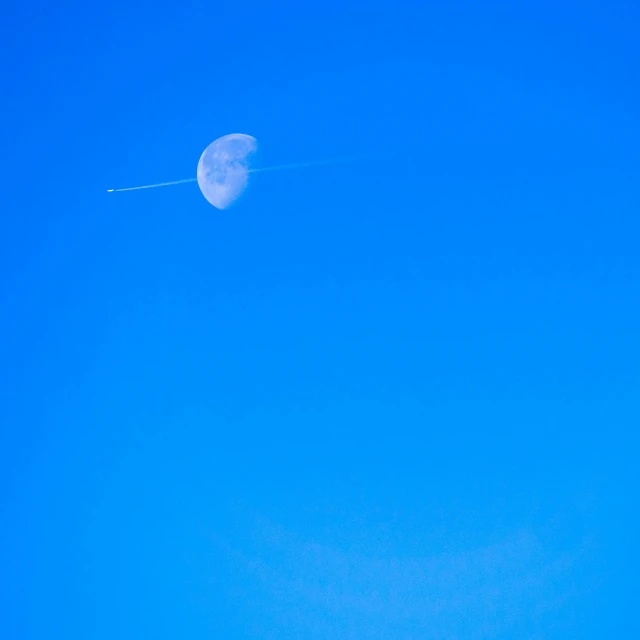 a clear sky with an airplane flying in the air