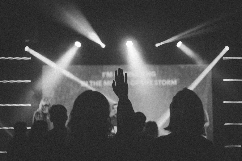 someone raised their hand to an audience at a concert