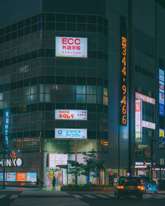 an image of a city at night with lots of neon signs