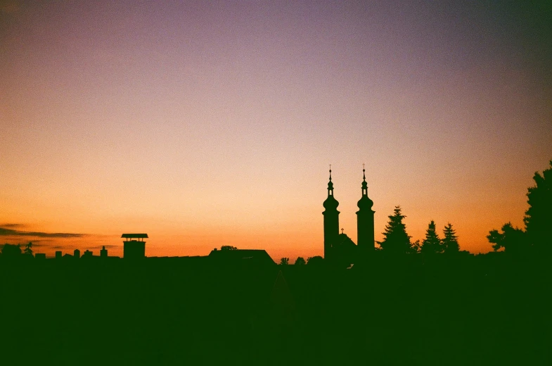 the silhouette of an old town, at dusk