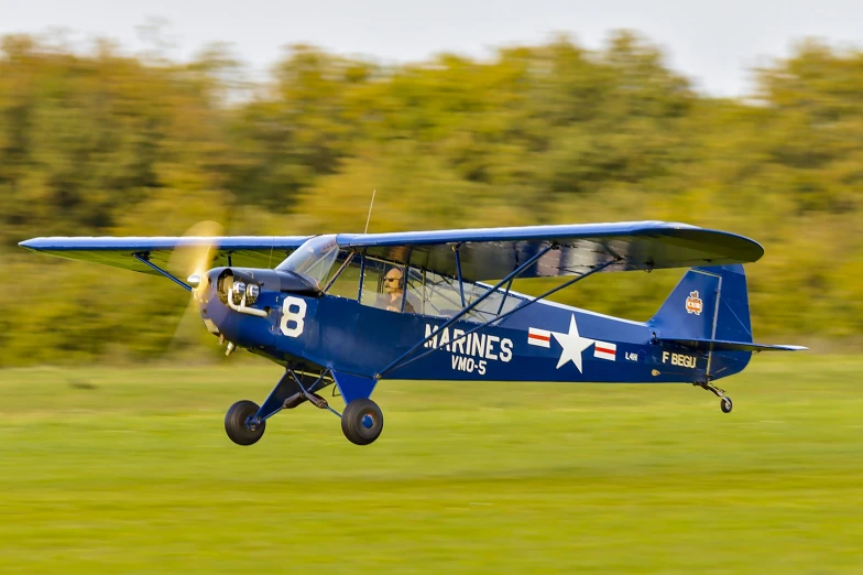 a small airplane is taking off from the field