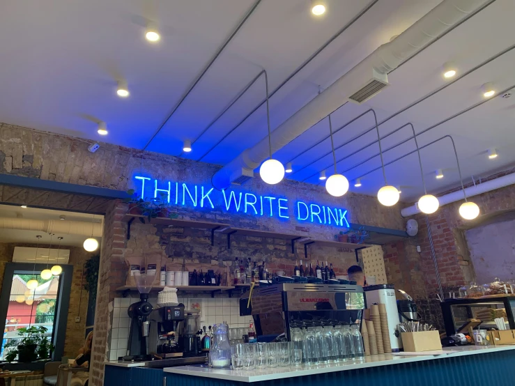 a restaurant with a light blue sign and blue lighting
