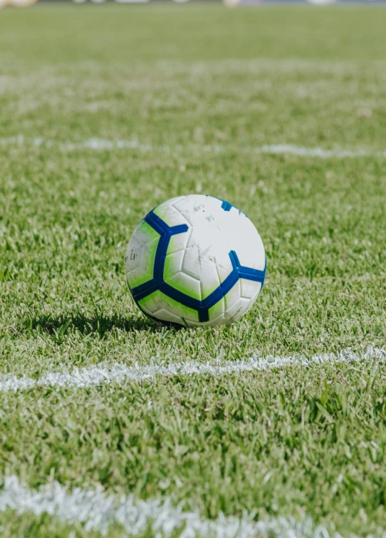 a soccer ball sitting on top of green grass