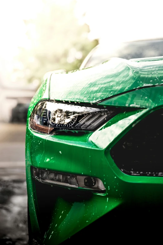 close up on the front of a bright green sports car