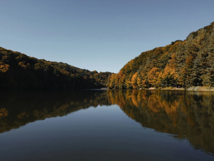 the water with trees in the background and sky