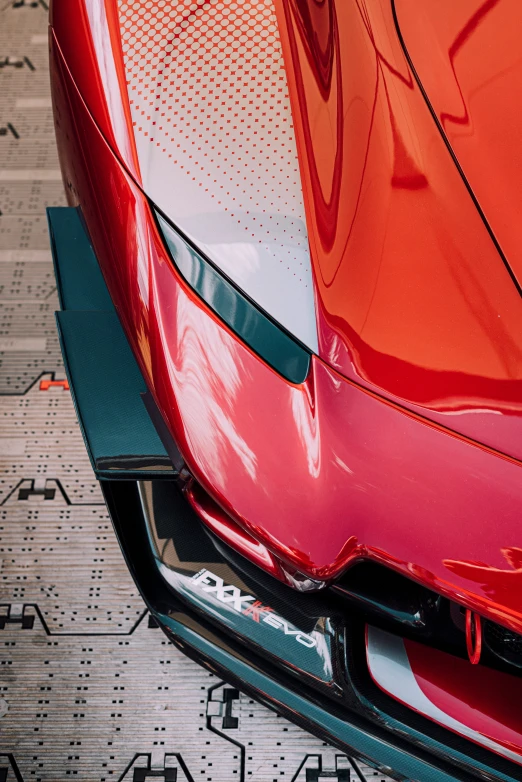 the front end of a red car on the ground