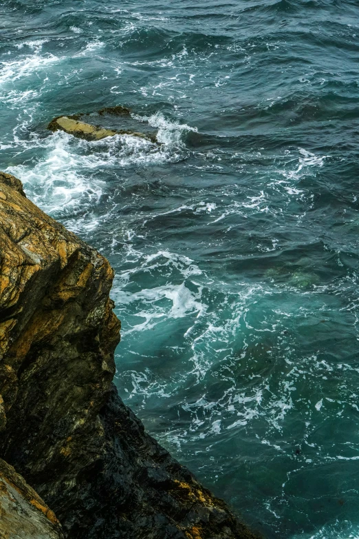 a large body of water that is next to a cliff