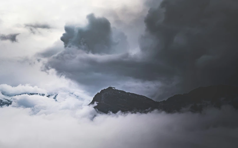 the clouds are in the sky on the mountains