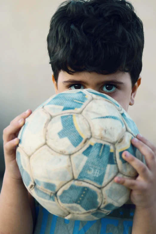 a  holding up a soccer ball