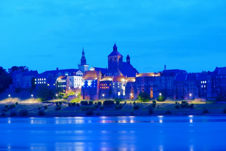 a beautiful european building lit up by the lights of a nearby building