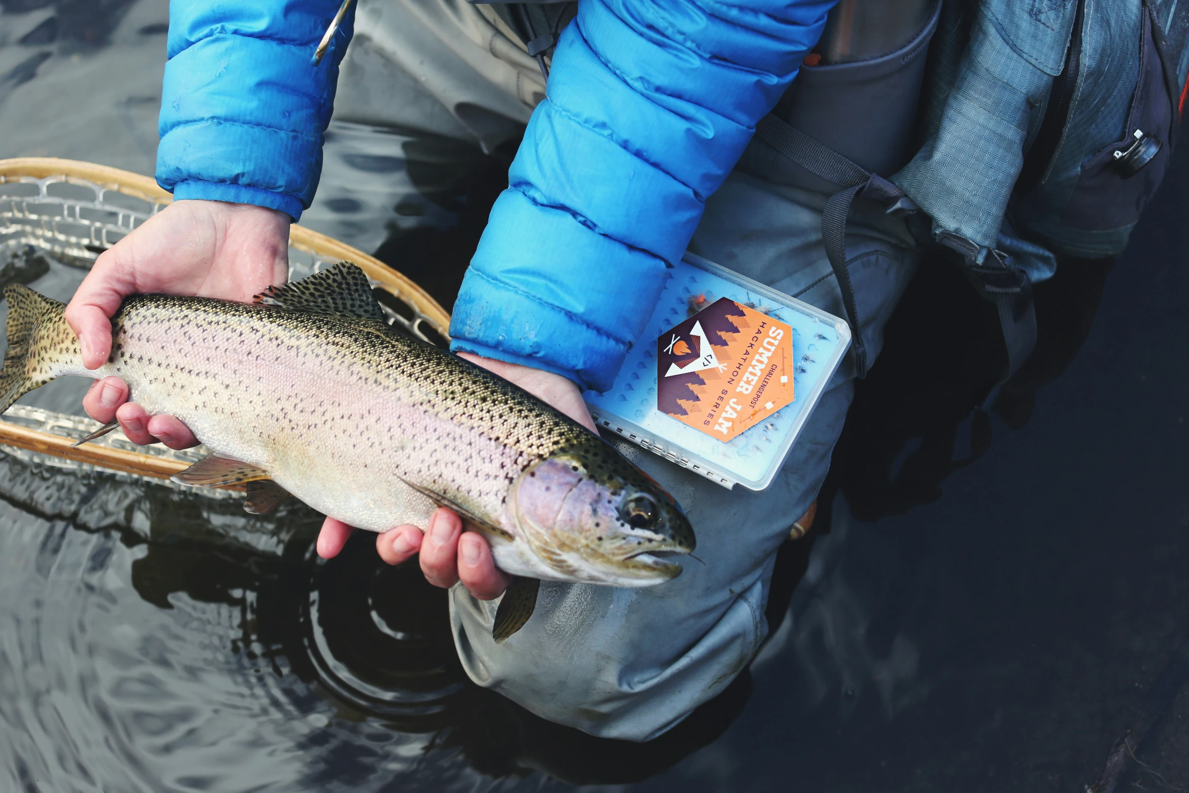 the man is holding the large fish in his hands