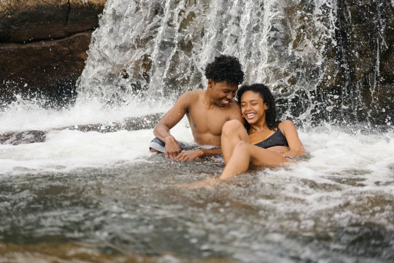 a man and woman are sitting on the water