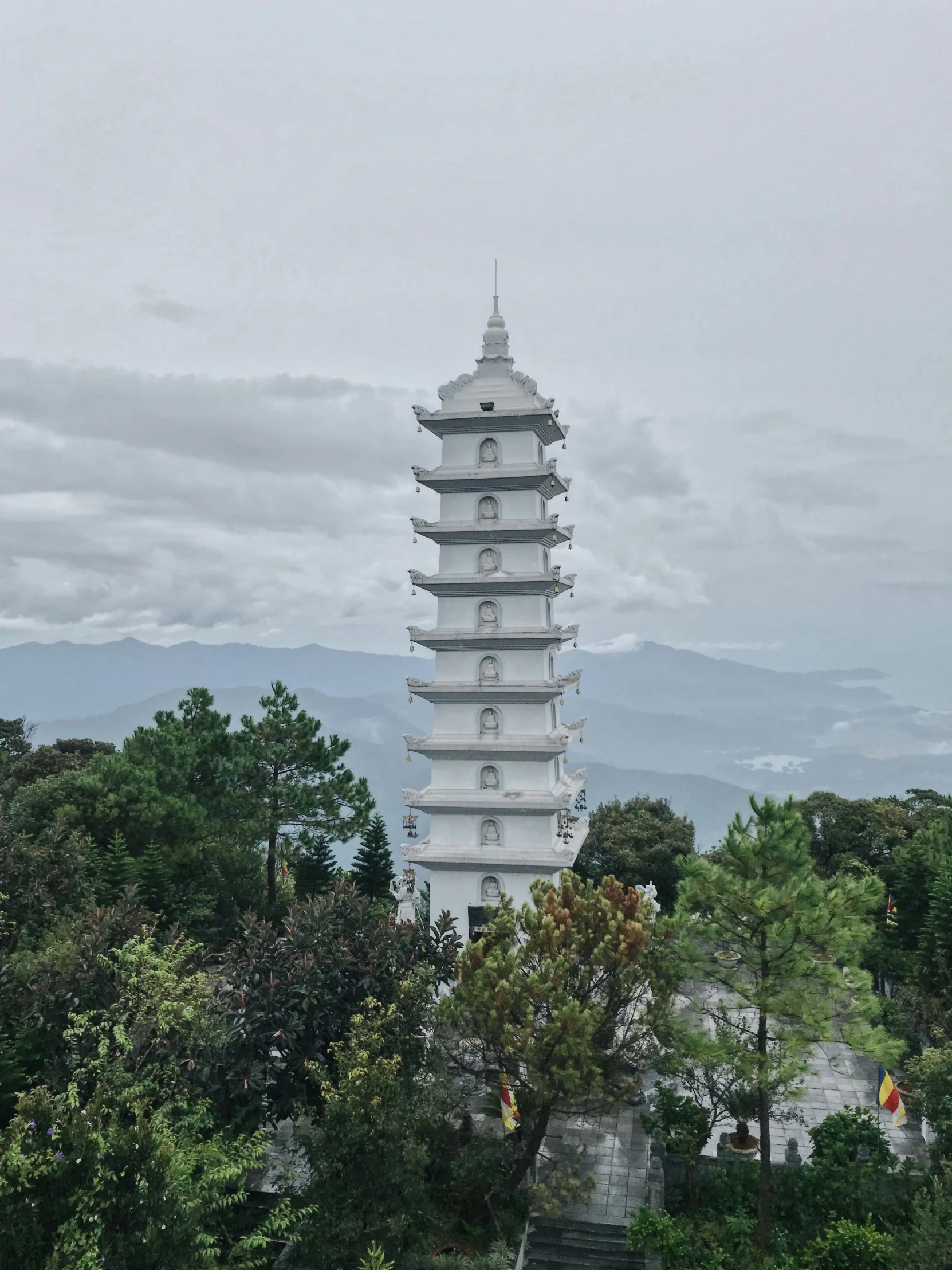 tall pagoda is sitting in a park overlooking trees