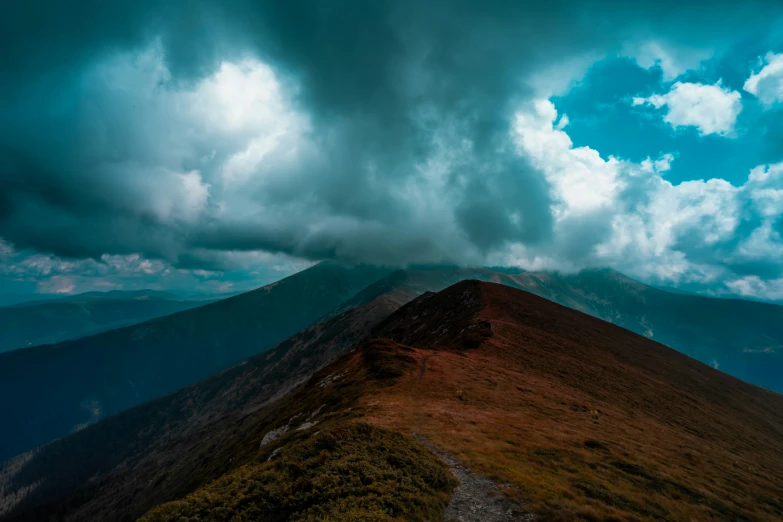 the sun is low on top of a high mountain