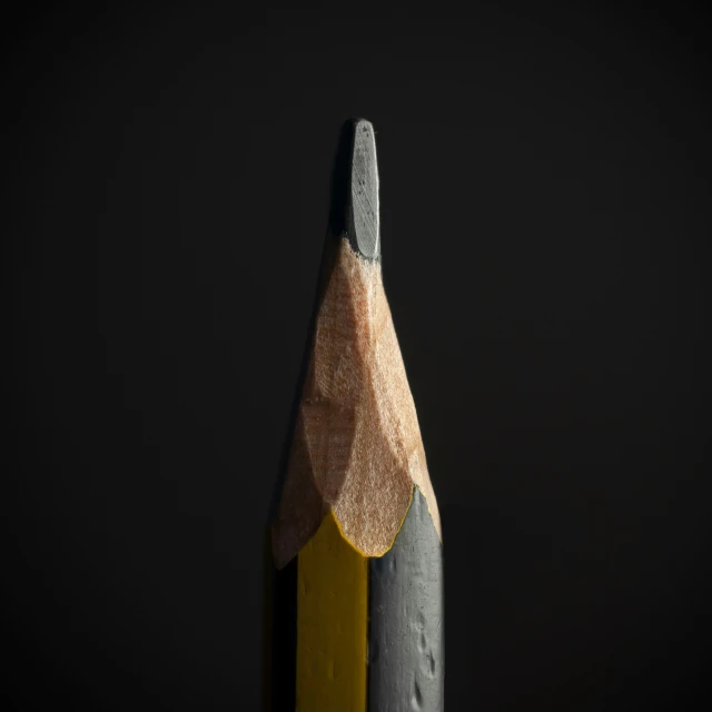 a pencil laying on top of another one