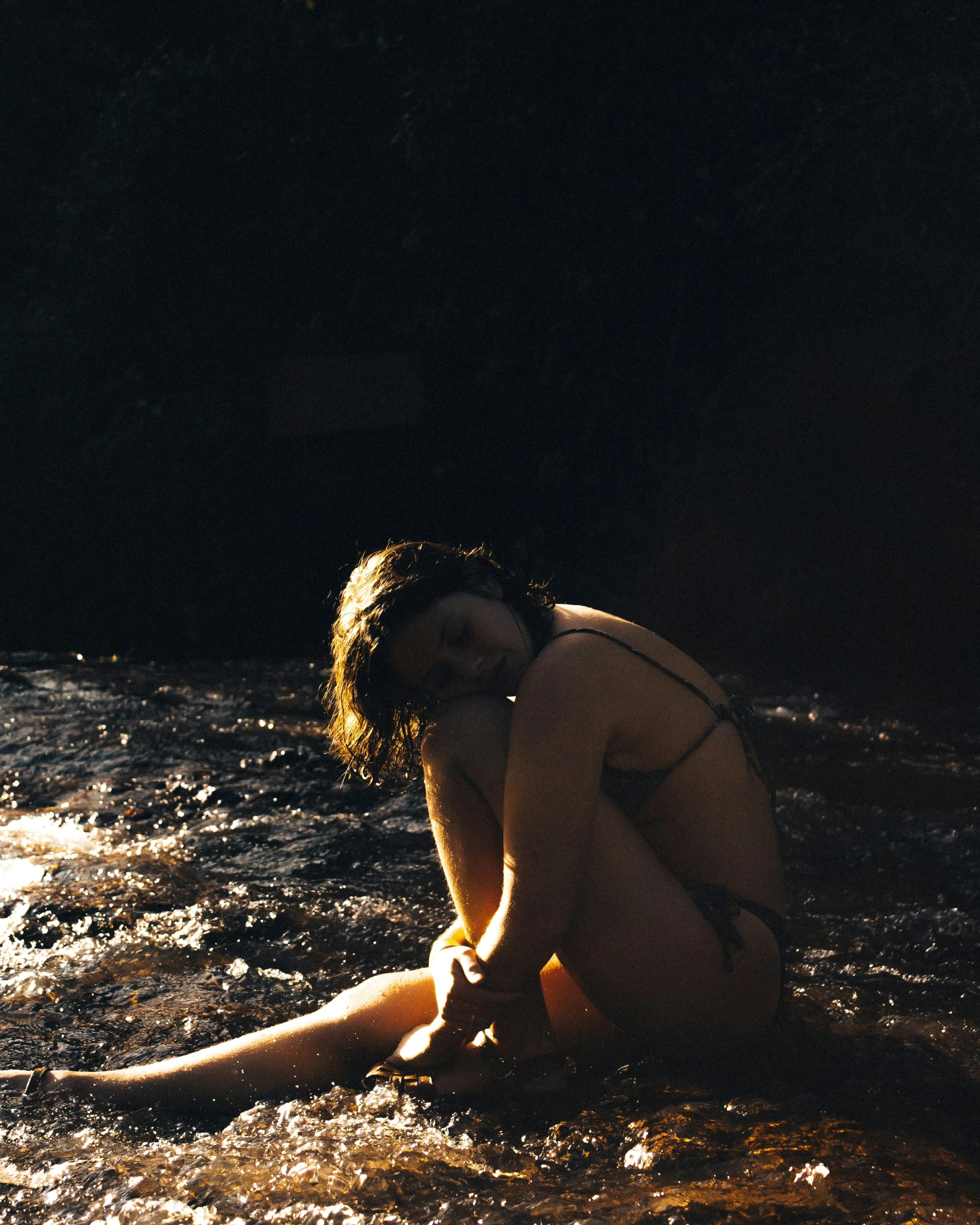 a  woman is laying down in the water