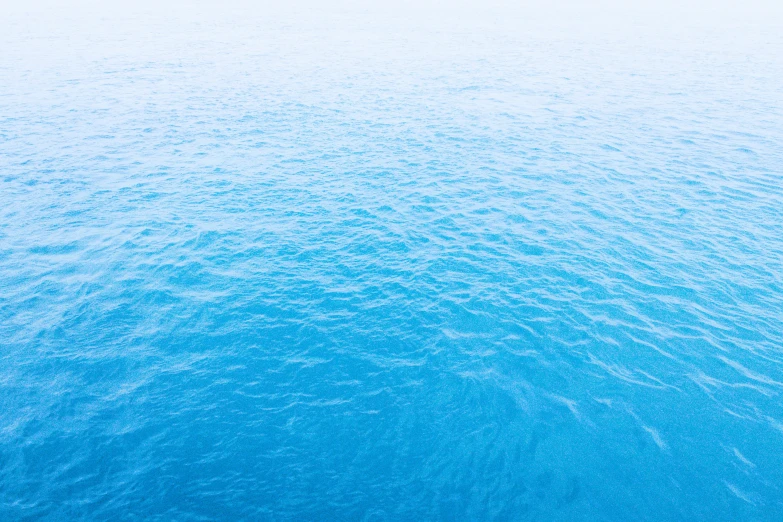 aerial view of large, blue water with ripples