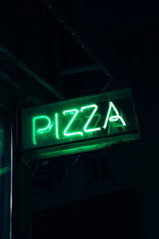 the sign is glowing green in the dark