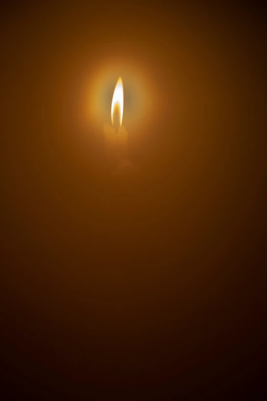 a candle that is lit on the top of a table