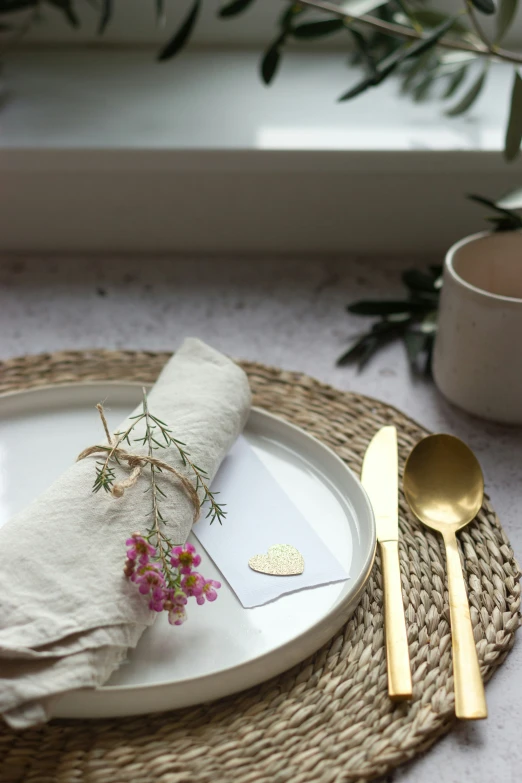 the place setting with flowers and a white plate