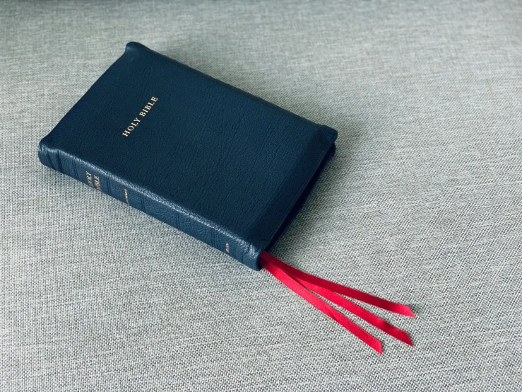 the blue book is next to a red tassel