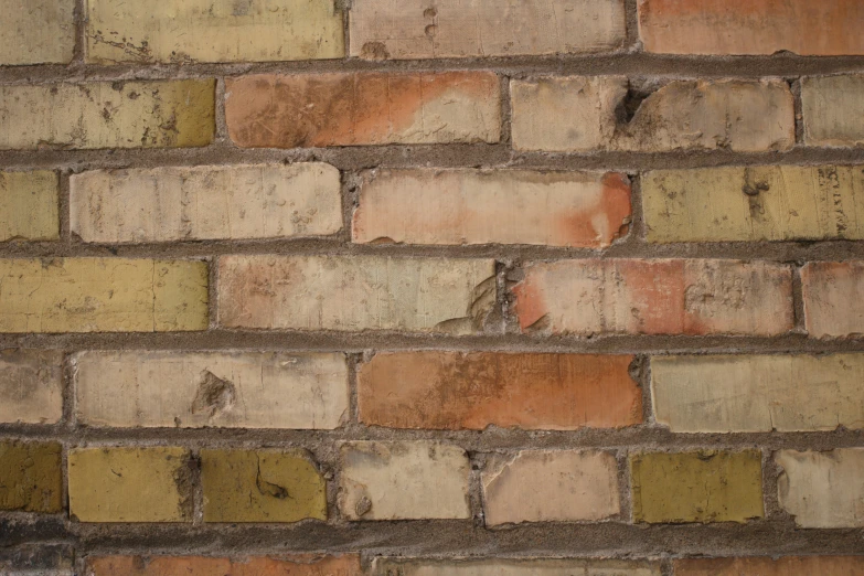 an old, burnt wall with several smaller orange bricks