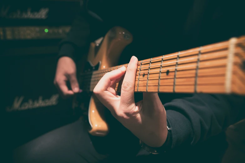 person playing on an electric guitar at night