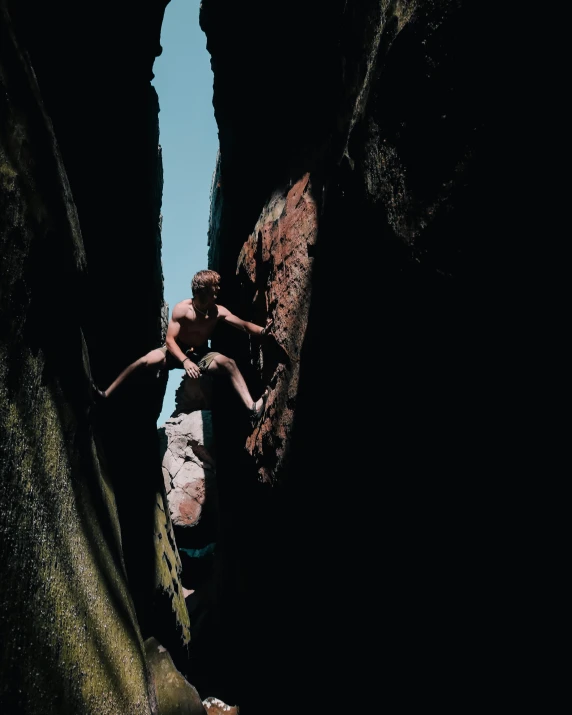 a person jumping off of a rock into the water