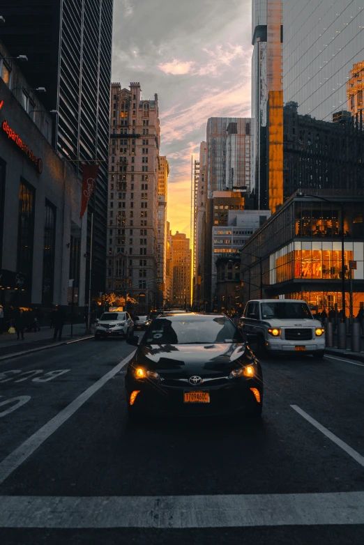 a car is driving on the street at dusk