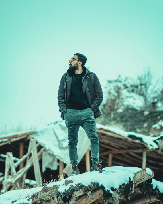 a man standing on top of a snow covered roof