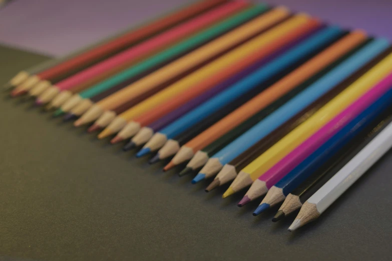 a close up po of colored pencils stacked together