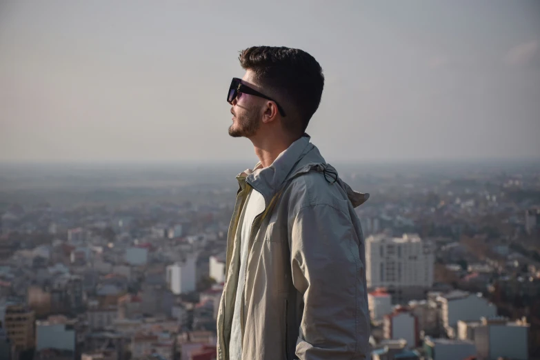 a man standing on top of a tall building