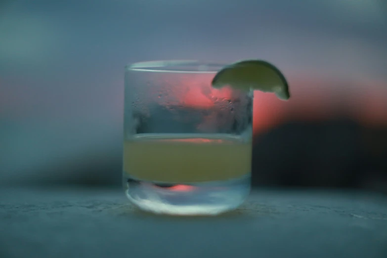 a s glass with a lime slice in it