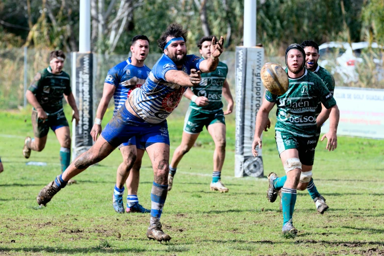 a group of men running along a field next to each other