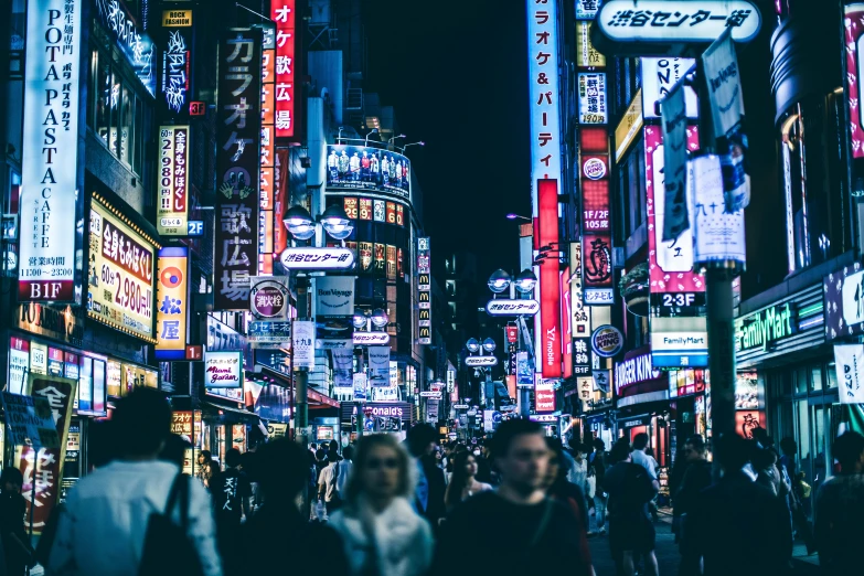 a crowded city street filled with lots of signs