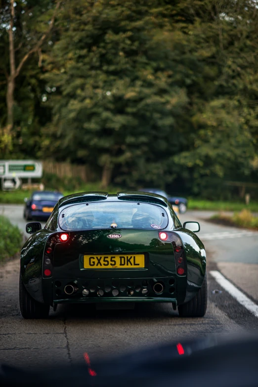 the car is driving along a narrow road