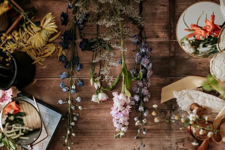 colorful flowers in vases, plates and a knife on a table