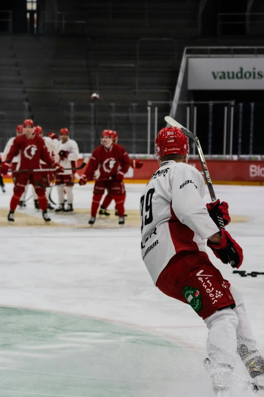 hockey players are walking across an ice rink