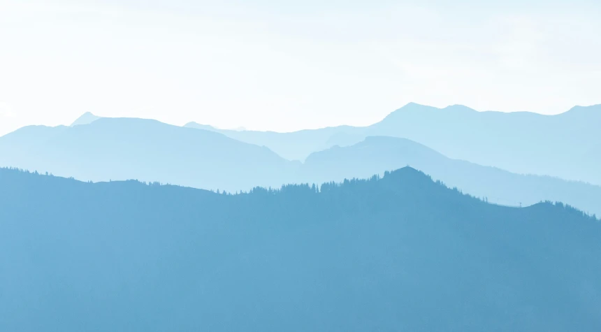 the top of a mountain in blue is shown