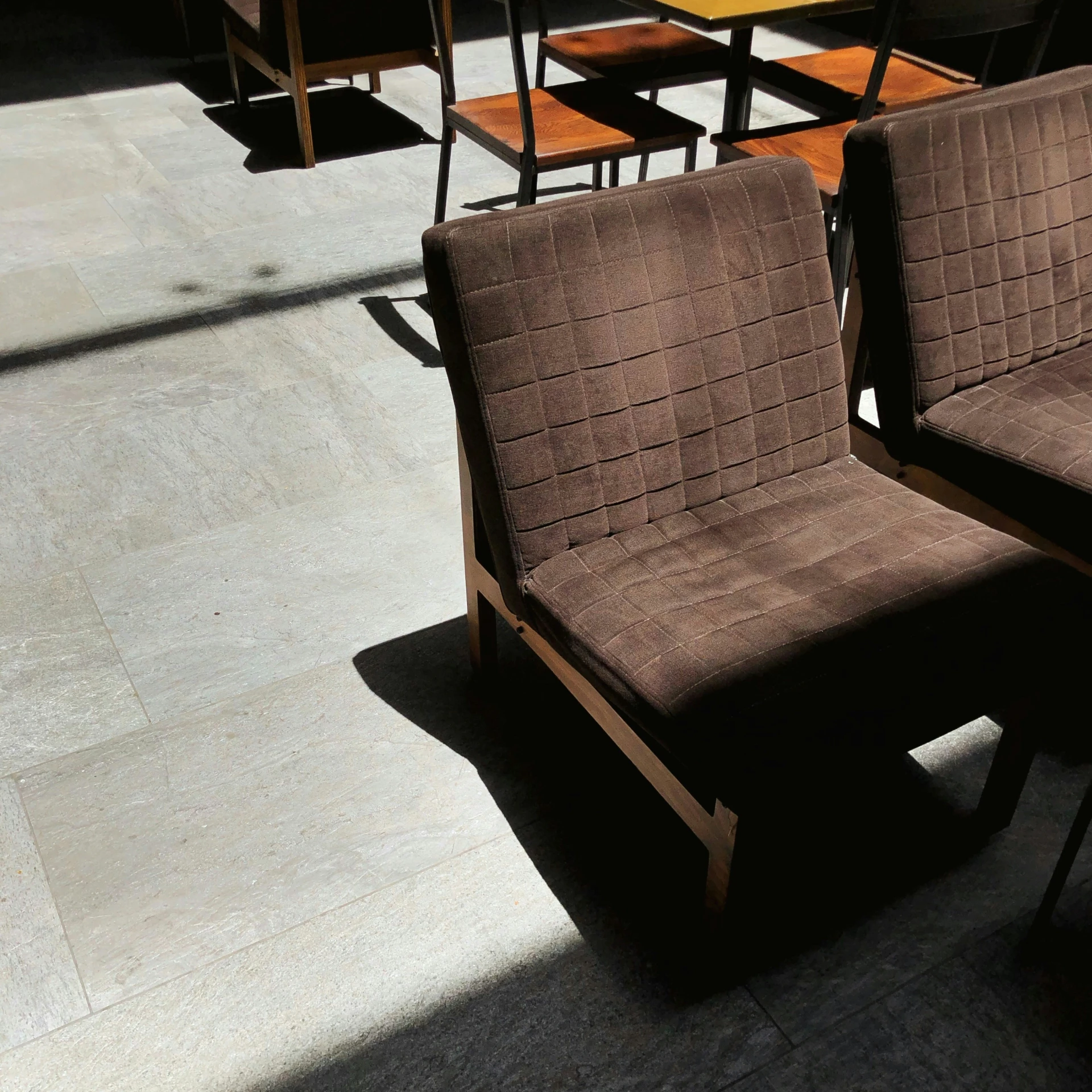 two chairs and table in sunlight at outdoor seating area