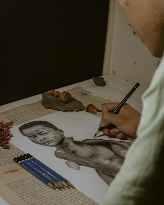a person is working on a drawing with a pencil