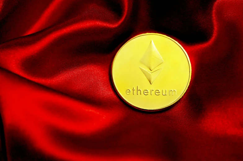 a gold coin is set on top of red cloth